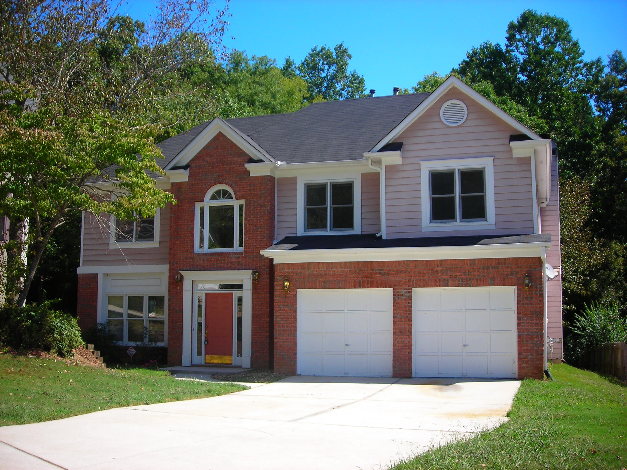 Red brick 2 story home, frontyard view