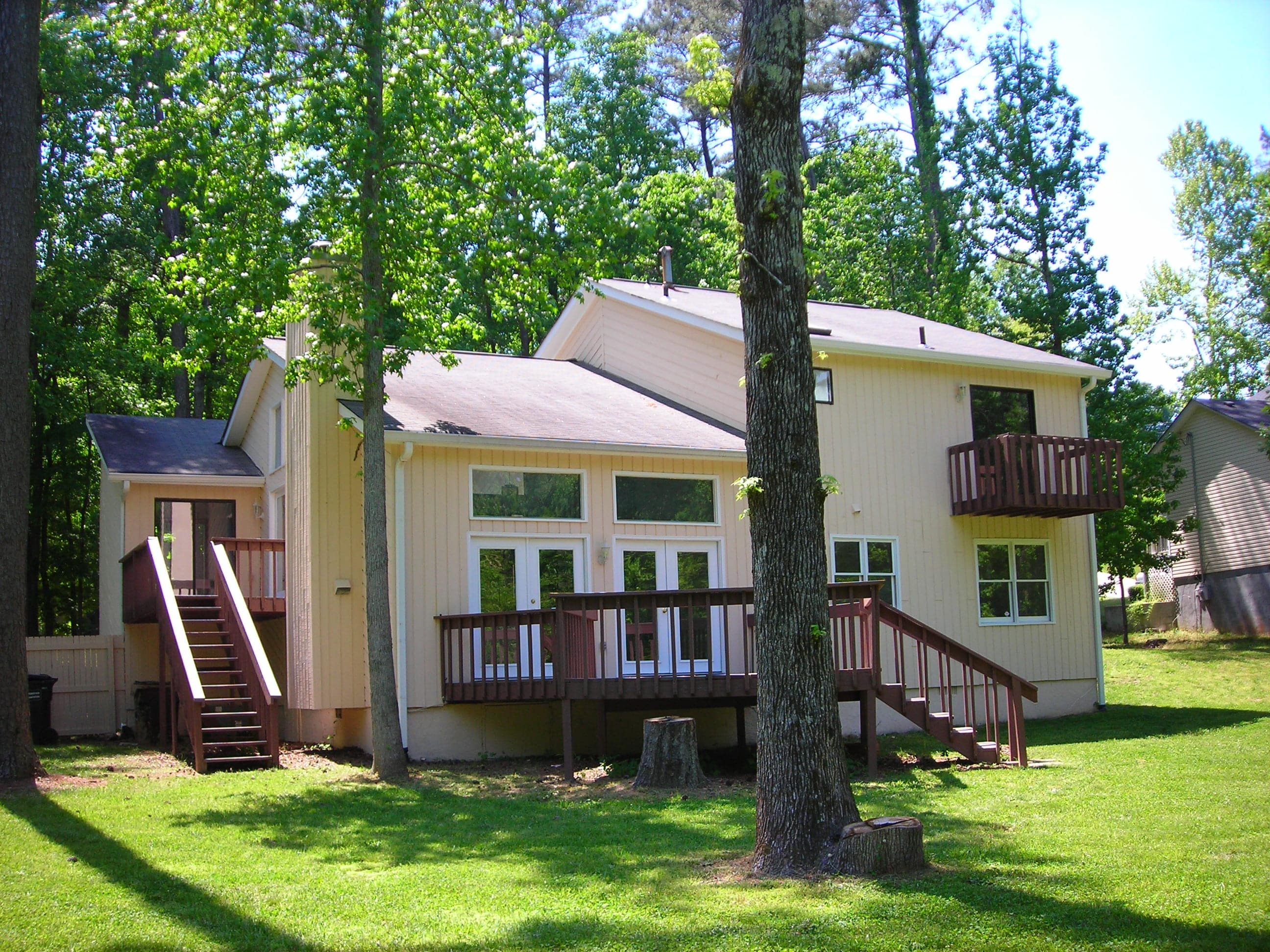 White home, backyard view of deck